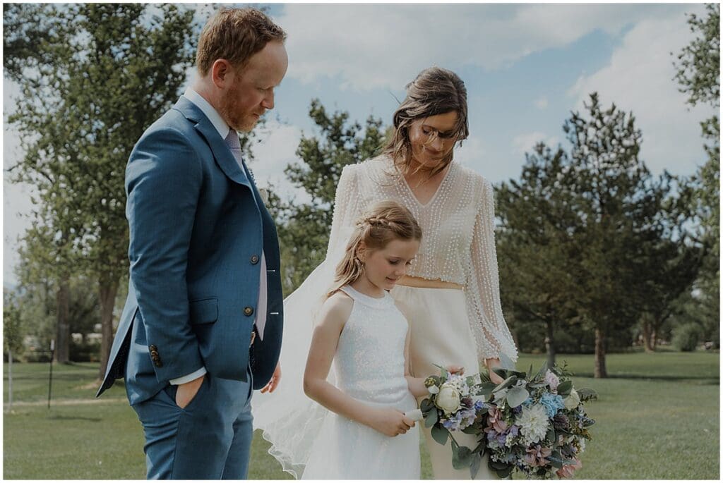 Couple with daughter on wedding day