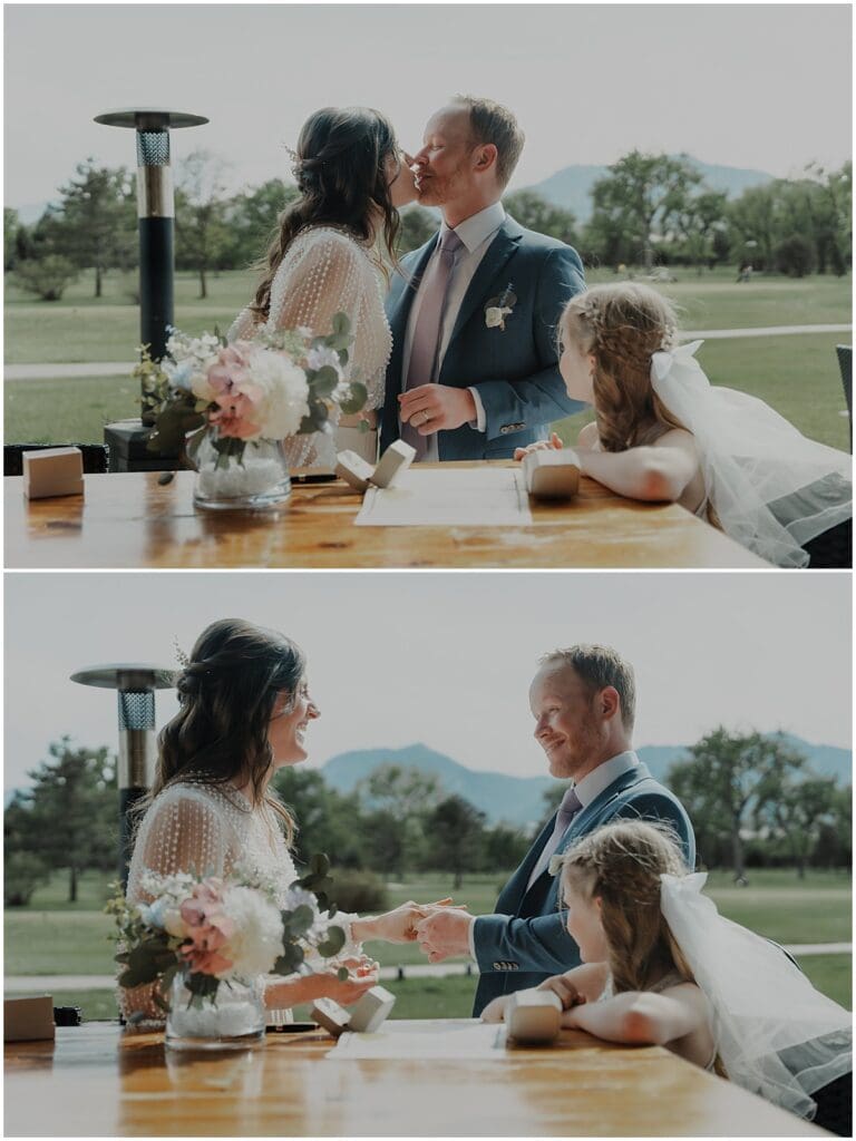 bride and groom signing marriage license with daughter looking on