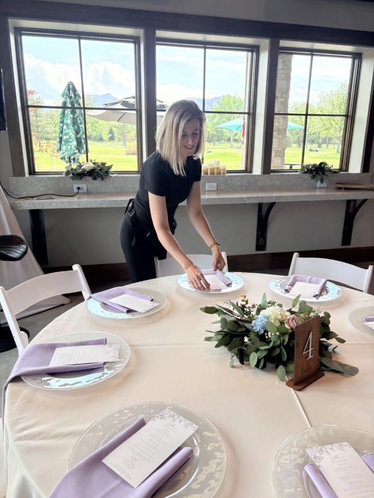 wedding coordinator setting up a table